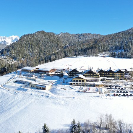 Resort with ski slope in the background and view of the Dachstein mountains